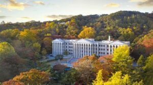 South Korea A beautiful building with columns nestled among lush trees in South Korea.