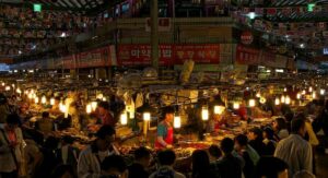 South Korea A bustling market in South Korea adorned with lanterns, where travelers can immerse themselves in the vibrant cultural scene while exploring the country.