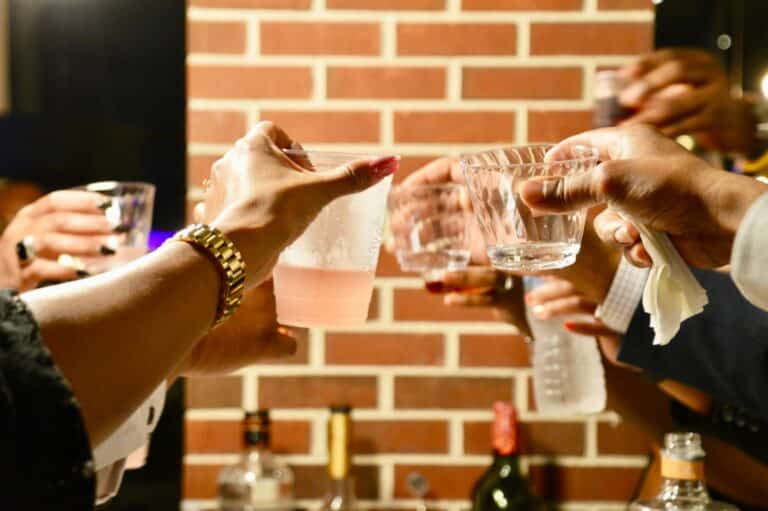 person holding clear drinking glass